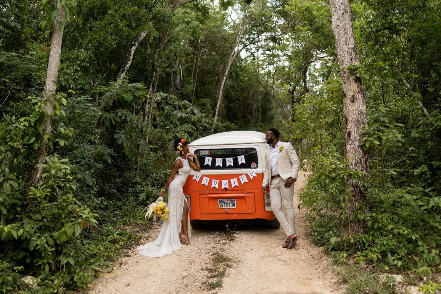 Wedding couple with orange van in the jungle